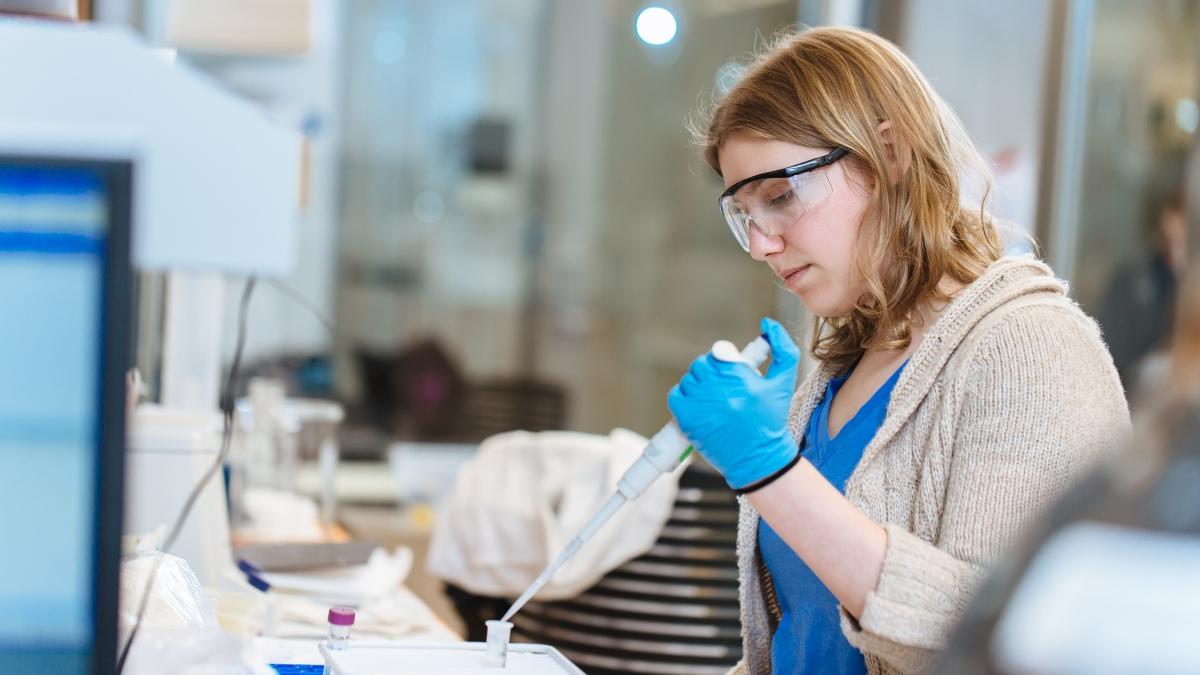Woman uses an advanced pipette for an experiment
